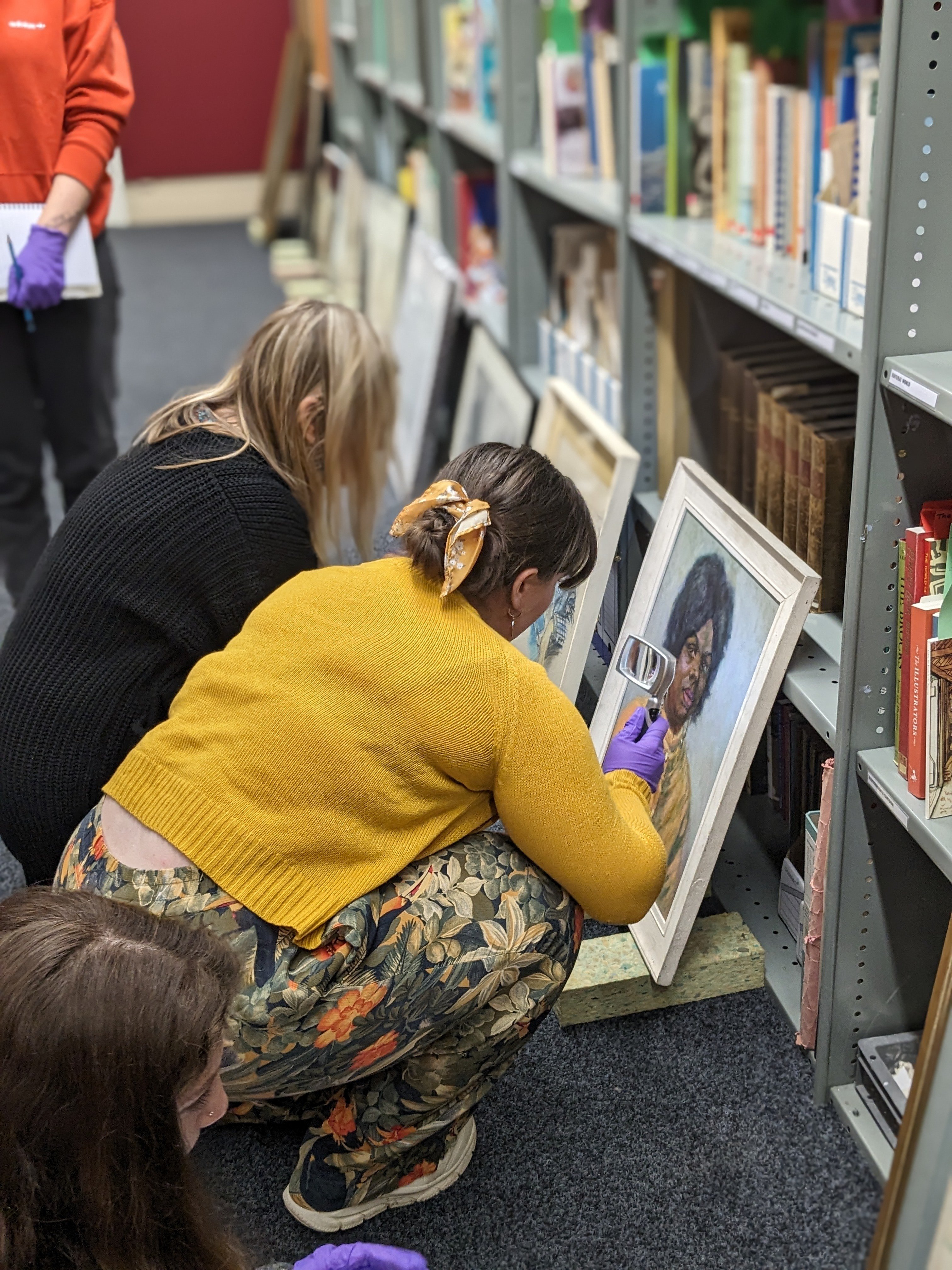 young people inspecting a painting