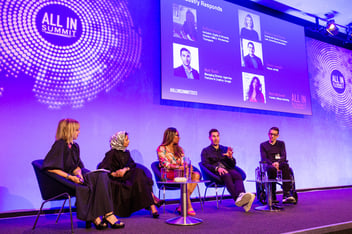five panellists on a stage with a purple background