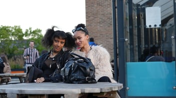 two people sat outside on a bench