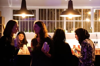 an image of people networking in a bar area