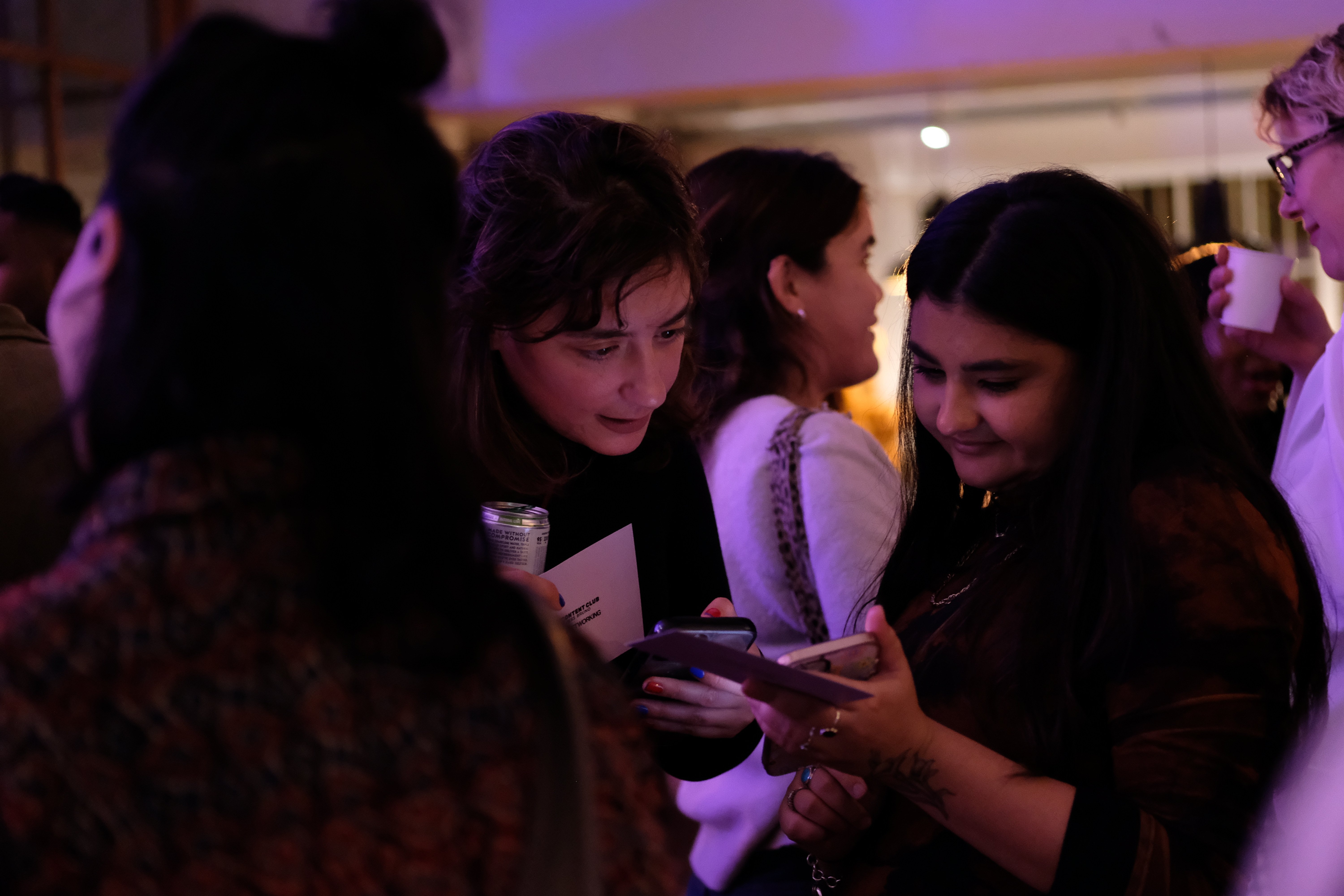 an image of two people networking, sharing information of a phone