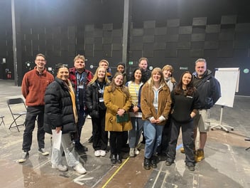 Participants of the West of England Film and High-End TV Workforce Development Programme wearing coats inside a studio space