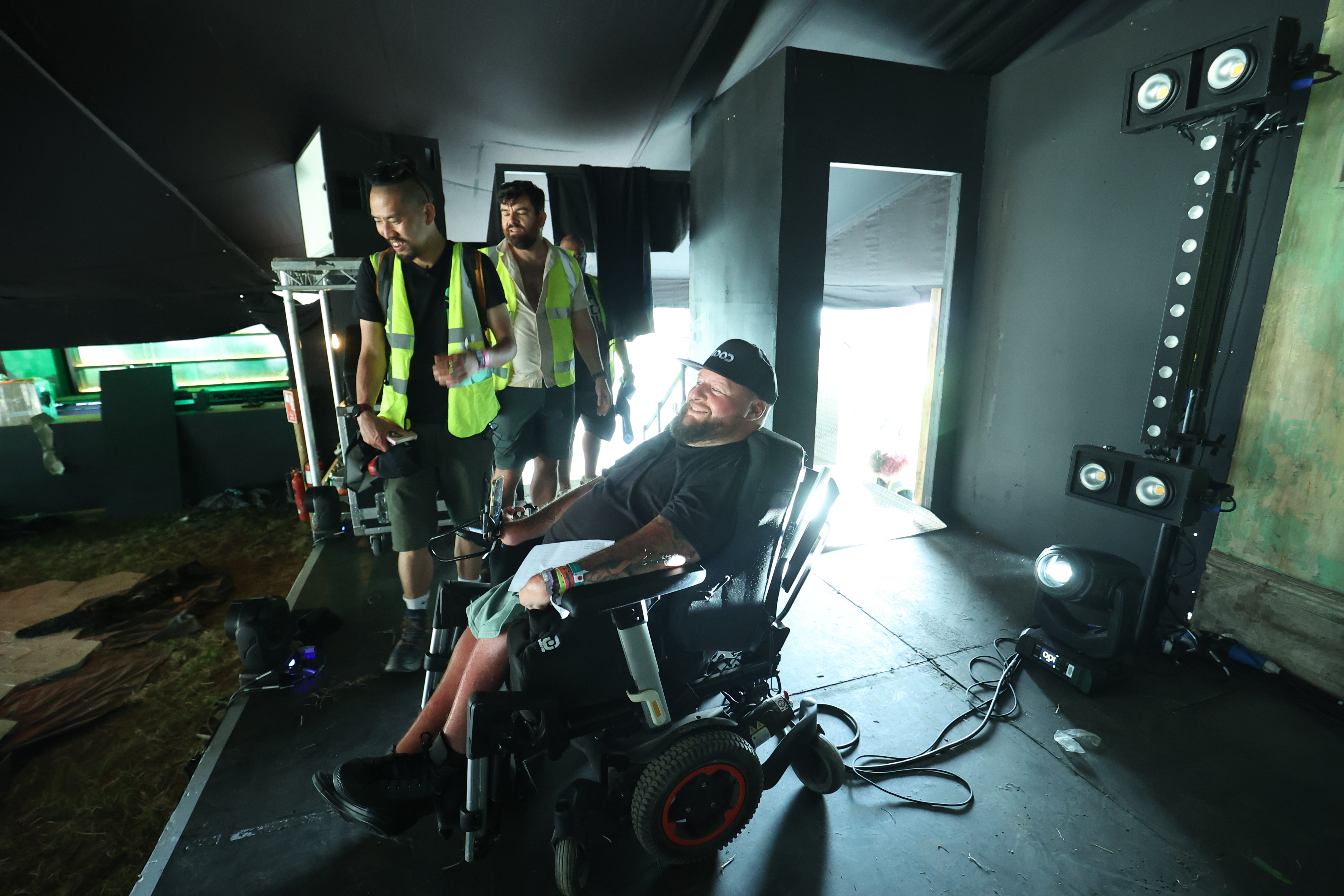 a wheelchair user on a stage at Glastonbury