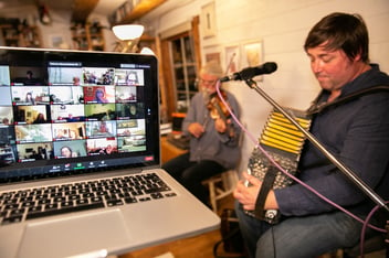 a musician performing to a zoom room on a laptop