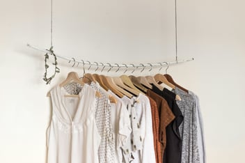 a selection of clothing on a rail